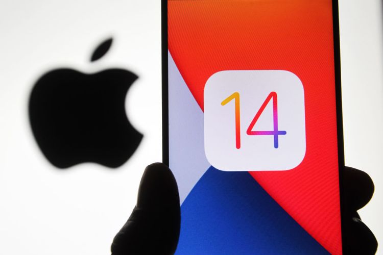 Photo illustration of the iOS 14 logo of the iOS mobile