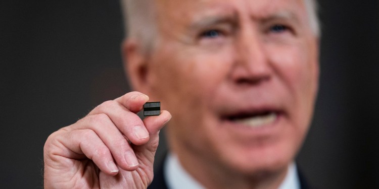 U.S. President Joe Biden holds a semiconductor during his remarks before signing an executive order on the economy in the State Dining Room of the White House on February 24, 2021 in Washington, DC.