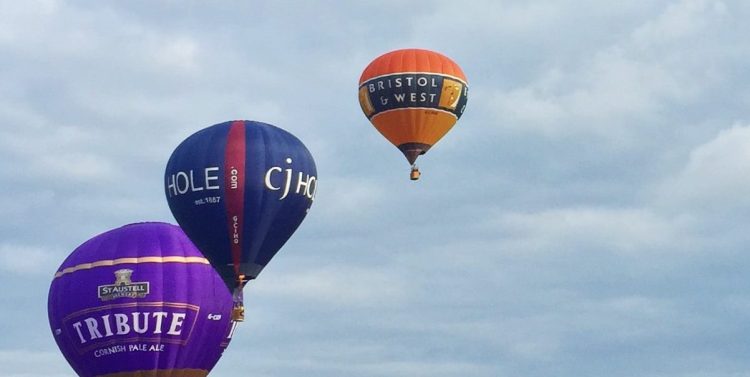 Hot air balloons flying into the sky as part of a race