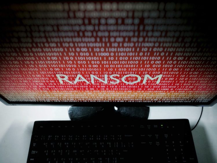 An image of a red computer screen with the words RANSOM written on it.
