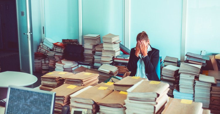 Overworked office worker, bureaucracy, archives.