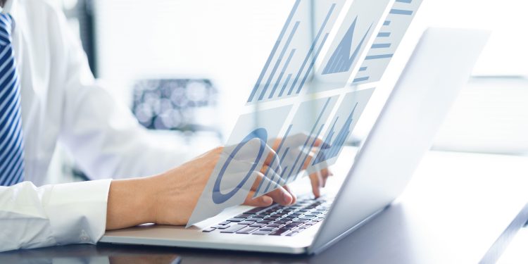 asian Businessman using virtual visual screen with laptop in office