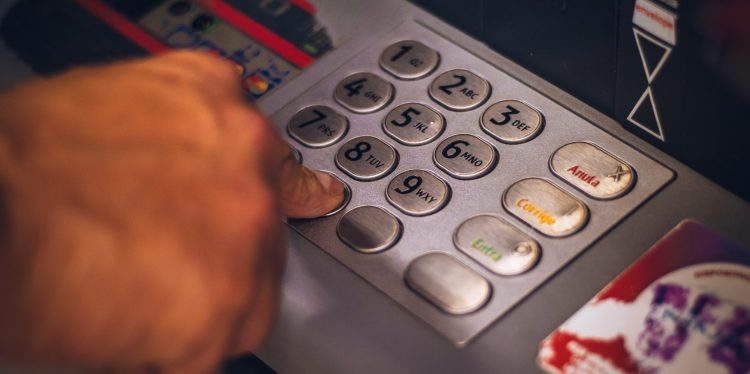 Using a ATM - Hand pressing number