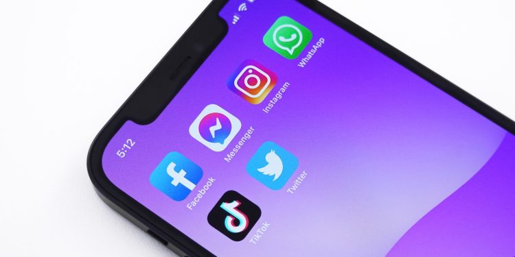 Graphic of a phone screen with the icons for popular Gen Z apps, like Twitter, TikTok, Messenger, Instagram, and WhatsApp