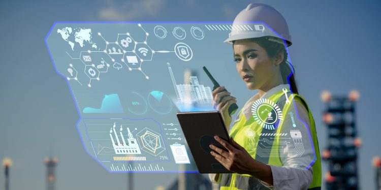 Technical Industrial Engineer working and control with monitoring system software and industry network connection on tablet.