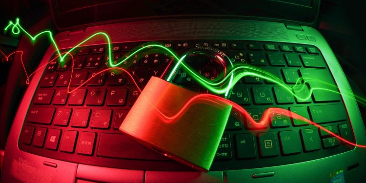 Lock with lines of light on a computer, represents cyber security.