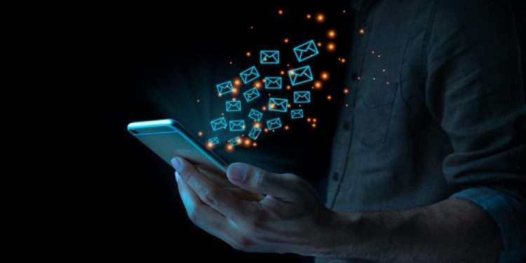 Close up of business man using mobile smart phone sending email