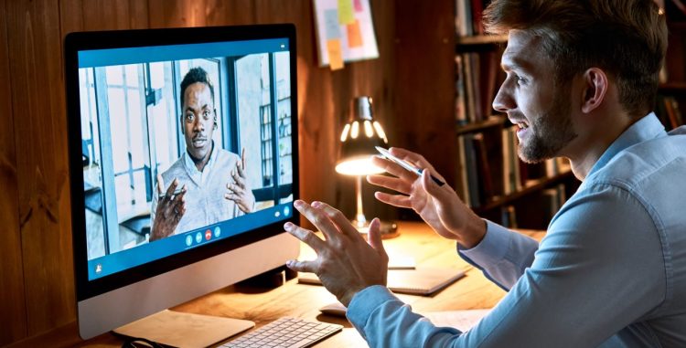 Businesspeople on video conference call discussing social distance work at virtual remote meeting videoconference chat using pc computer at home office.