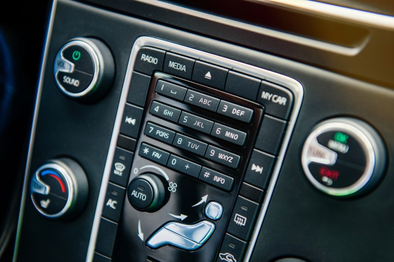 Modern luxury car dashboard with control of the phone dials, AC air conditioning levels, Radio, Media , my car and Auto buttons