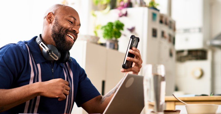 Black man in his 30s flexible working from home, online meeting, wireless technology, adapting to new normal
