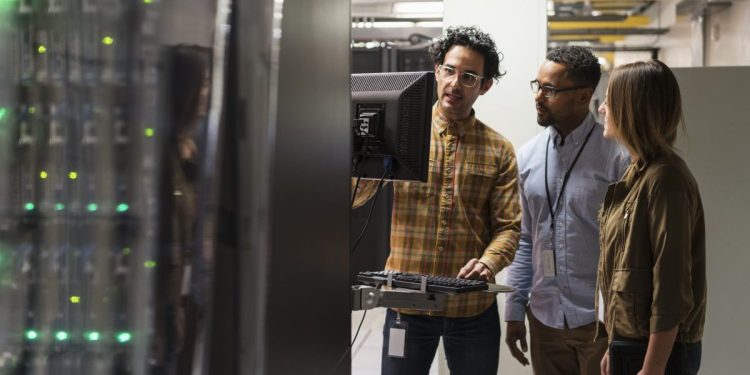 IT team performing cybersecurity procedures in server room