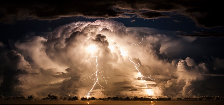 Storm clouds shrouStormy night over Byron Bayd an electrical storm of the coast of Byron Bay at night. Taken from the hinterland around Mullumbimby, early evening in Autumn as the changing sky dazzles with a natural light show of lightning bolts and billowing clouds dance in the sky for hours.