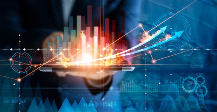 Business person using tablet analyzing sales data and economic growth graph chart.