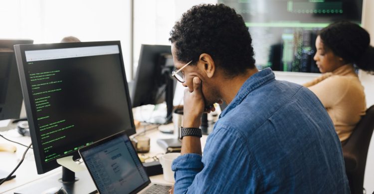employee digital builder looking at laptop screen