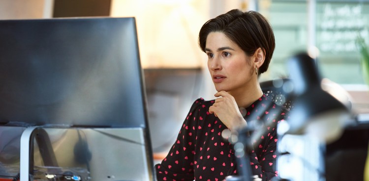 Mid adult woman working at desk in office, connection, planning, communication