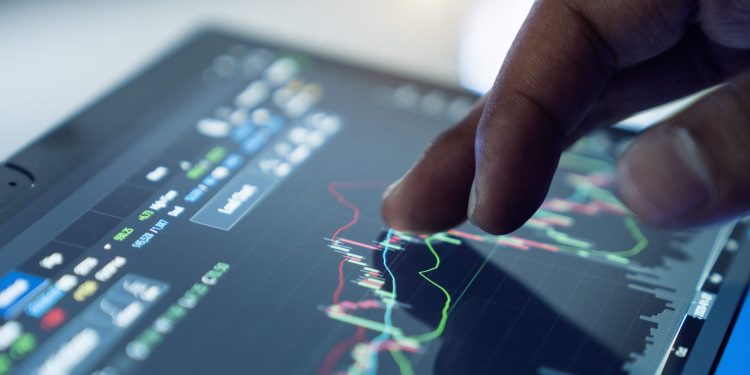 data management Market Analyze with Digital Monitor focus on tip of finger.