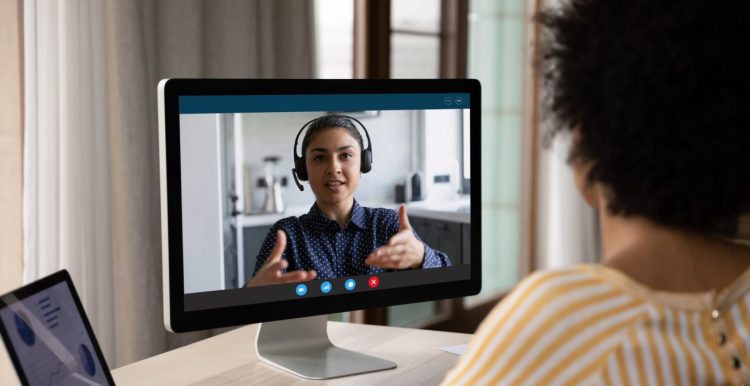 African American customer woman talking to support service employee, operator on video call. Female business coworkers discussing project marketing report on distance virtual chat at computer monitor