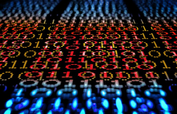 Binary code, ones and zeros in a 1970 dot matrix font on a computer screen. An infinity and lens bokeh effect applied.