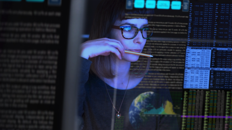 Security analyst observing data on a large tablet.