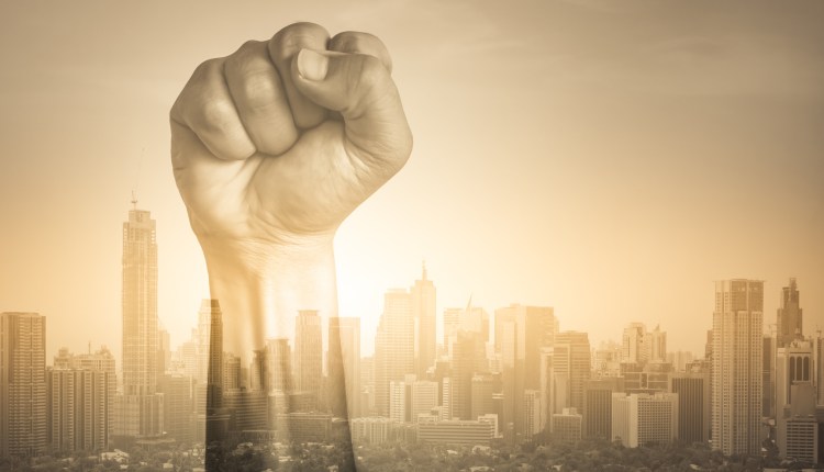 Fist in the air with city ESG concept image