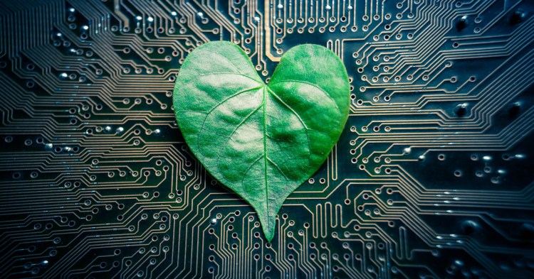 A green leaf with a heart shape on a computer circuit board