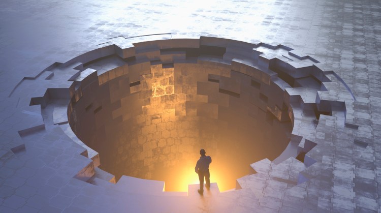 Person examining glowing metal hole