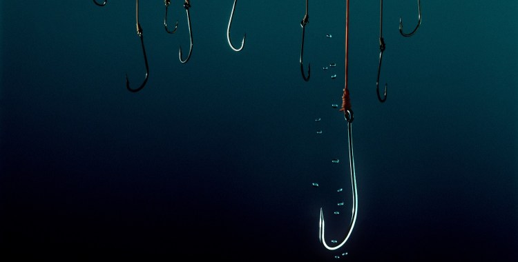 Fishing hooks in water. Phishing concept