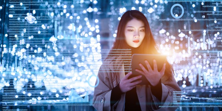 Person uses digital tablet on virtual visual screen at night