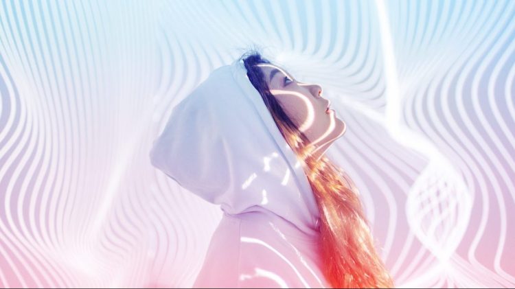 Young woman standing in holographic background