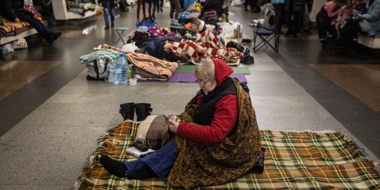  A woman uses her mobile phone as she takes shelter in the Dorohozhychi subway station which has has been turned into a bomb shelter on March 02, 2022 in Kyiv, Ukraine.