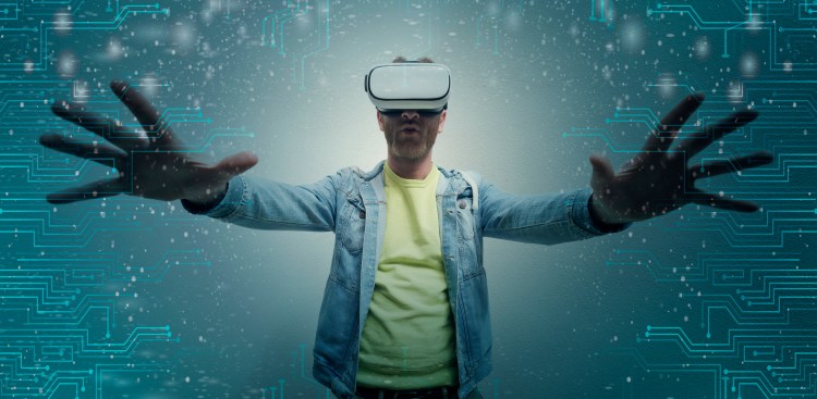 Excited Young man wearing VR glasses.