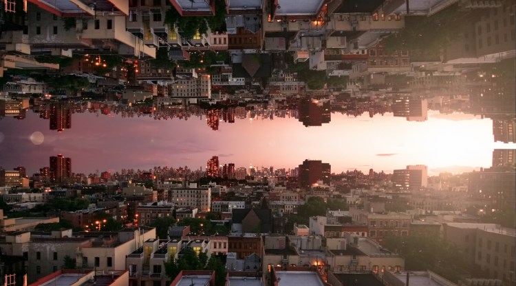 Capsized reflected image of horizon at sunset over rooftops in Harlem, New York City