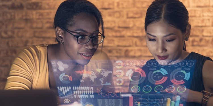 businesswomen using advance technology hologram computer display business information data