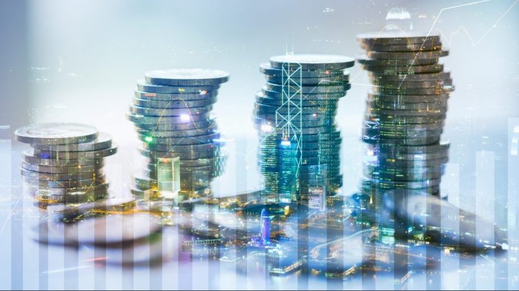 Double exposure of city with graph and stack of coins for finance and business concept