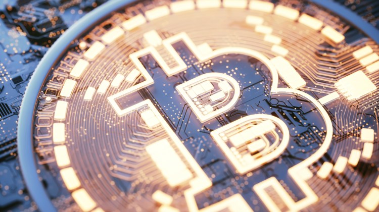 Bitcoin logo on circuit board, illustration.