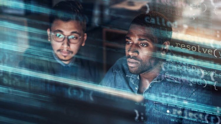 Digitally enhanced shot of two handsome businessmen working in the office superimposed over multiple lines of computer code