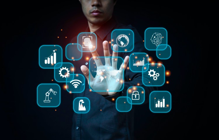Businessmen point to holograms used to control AI (Artificial Intelligence) operations in modern industrial plants, Industry and technology concept