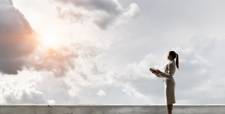 Young business person on top of building against cityscape