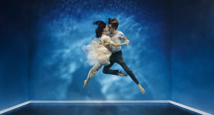 A couple dancing under water in a intimate moment. Embodied reality concept