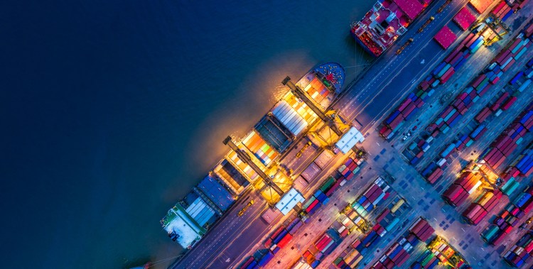 Container ship in import export and business logistics, By crane, Trade Port, Shipping cargo to harbor, Aerial view from drone, International transportation, Business logistics concept