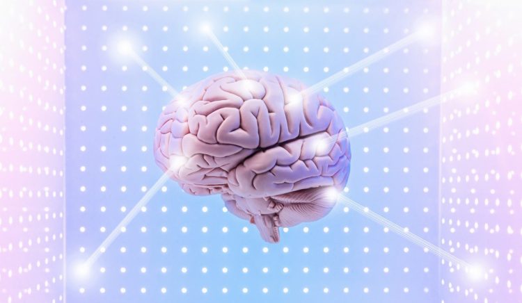 Model of human brain surrounded on 3 sides by panels with grid pattern, connected by 6 beams of light