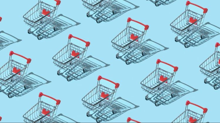 Pattern made of shopping trolley on blue background. Shopping, ecommerce and sale concept