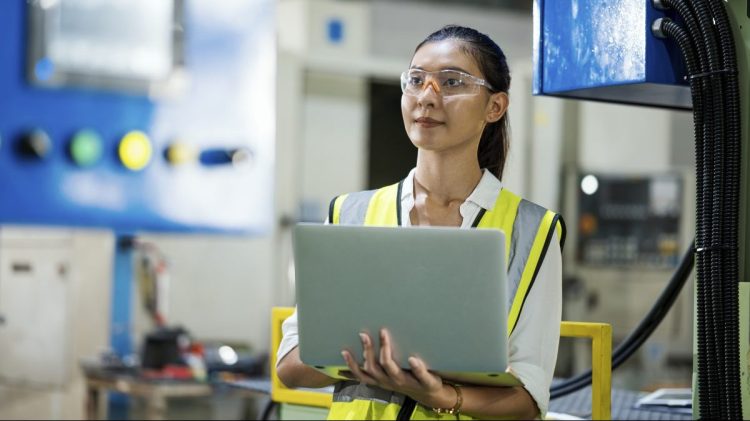 Woman engineer checking mechanical processes using automation technology.