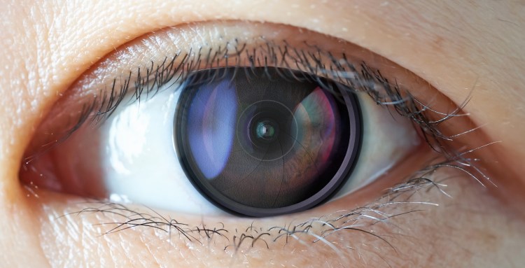 Closeup of camera len inside the women eye , futuristic digital vision augmented reality technology concept