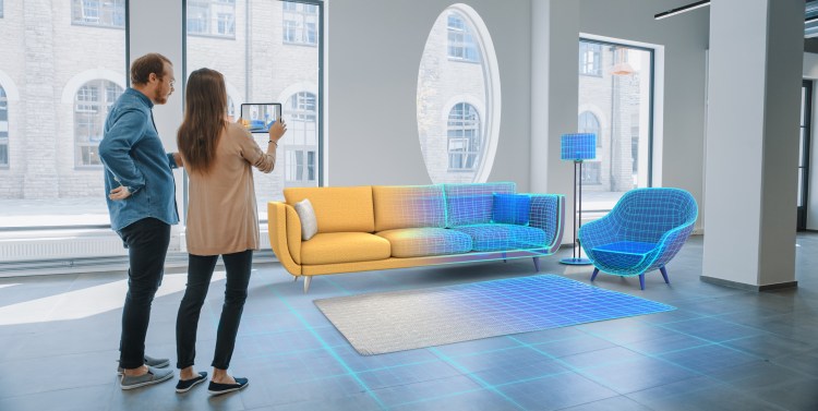 Decorating Apartment: Lovely Young Couple Use Digital Tablet with Augmented Reality Interior Design Software to Choose 3D Furniture for their Home. People Pick Sofa, Table and Lighting for Living Room
