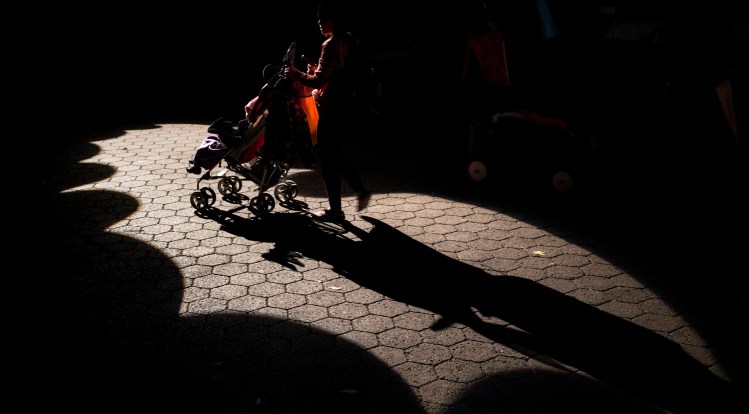 A hold in a stroller is wheeled through a Batman logo during Boo at the Zoo at the Smithsonian's National Zoo October 25, 2013 in Washington, DC.