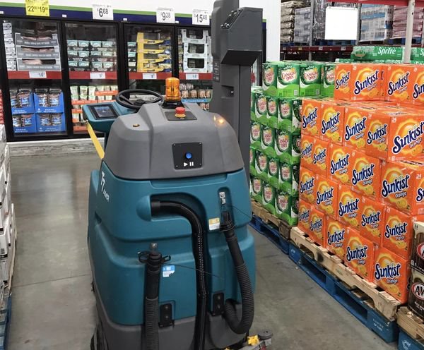 photo of the ML bot floor mopper at Sams Club next to products
