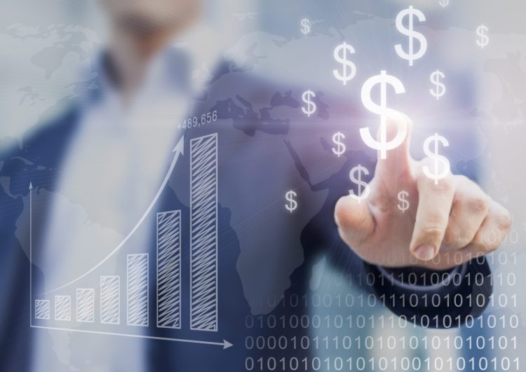 Businessman presenting financial analysis with charts generated by big data displaying international success and dollar signs, tech spending
