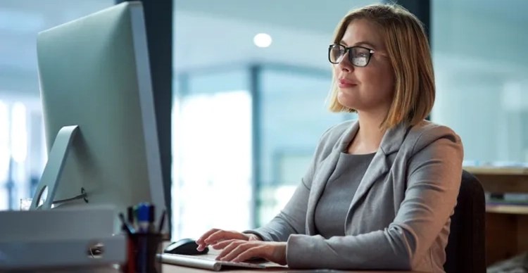 Woman typing at desk.